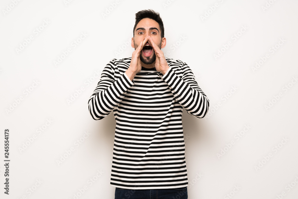 handsome man with striped shirt shouting and announcing something handsome man with striped shirt shouting and announcing something
