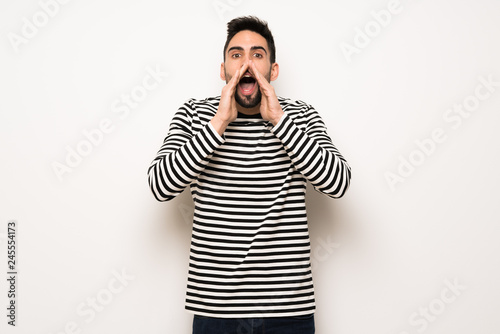 handsome man with striped shirt shouting and announcing something
