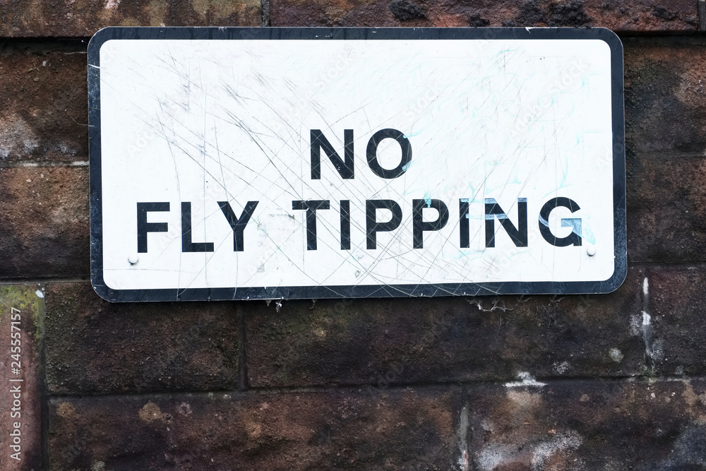 No fly tipping sign on council estate wall No fly tipping sign on council estate wall