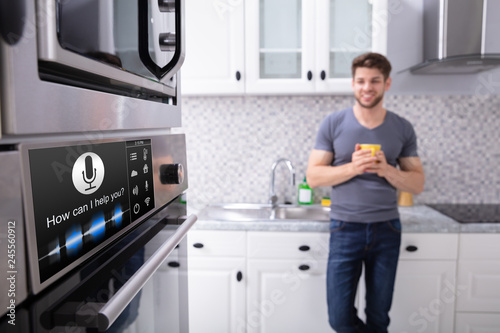 Man Looking At Oven With Voice Recognition Function