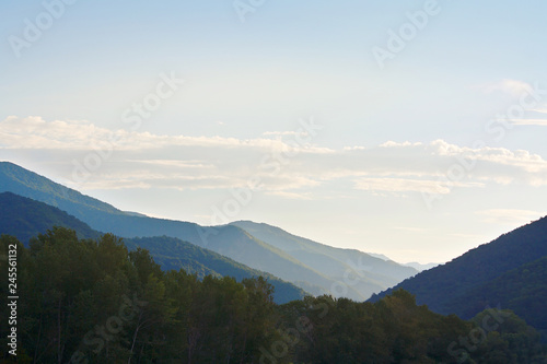 Fototapeta Naklejka Na Ścianę i Meble -  Beautiful early morning sunlight in the mountains covered with forests