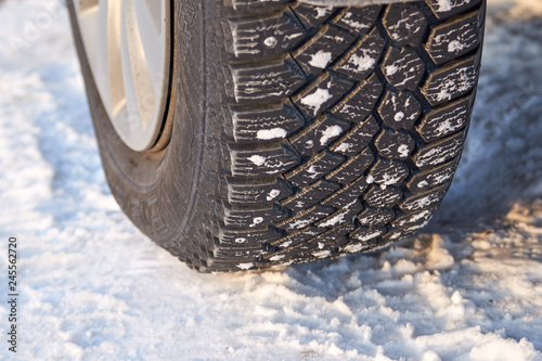 Winter car tires on the snow on the road. © Oleg Picolli