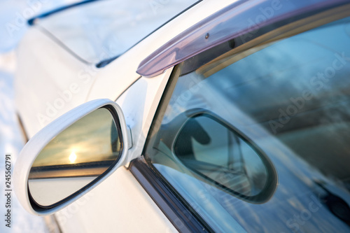 view from the side of the passenger mirror and the window of the white car. concept car rearview mirror