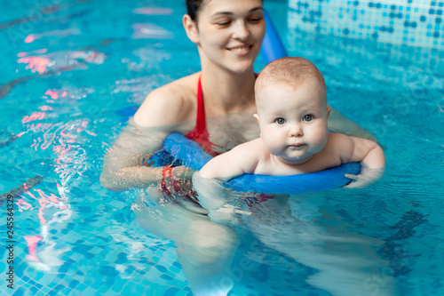baby with mom learns to swim in the pool © artem_goncharov