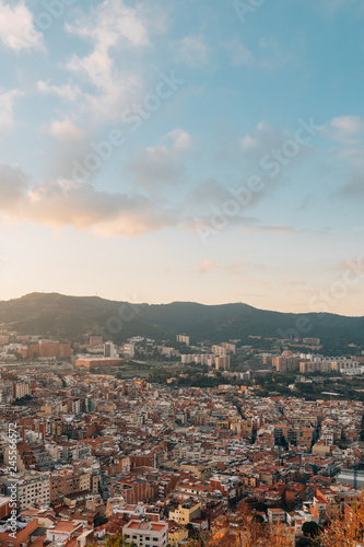 Cityscape and mountains sunset view from Bunkers Del Carmel, in Barcelona, Spain