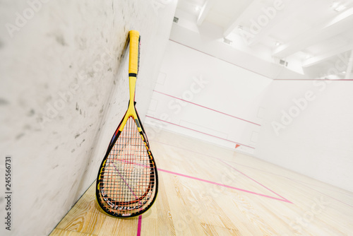 Closeup photo of squash rackets on empty squash court photo