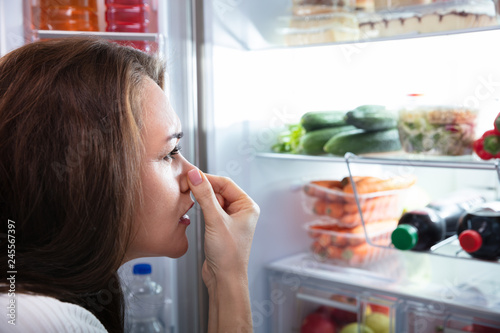 Woman Recognizing Bad Smell From The Refrigerator