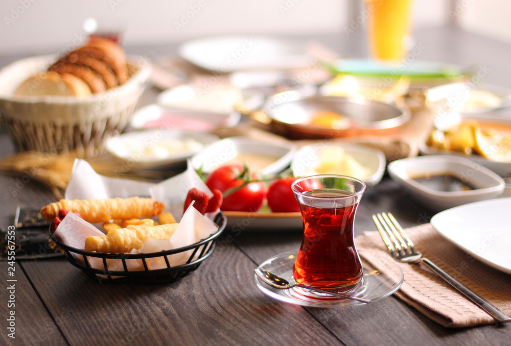 A cup of freshly-fermented tea for breakfast with bread wheat tomato cheese sausage
