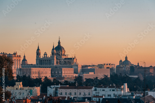 View of the Almudena Cathedral at sunset, from the Templo de Debod, in Madrid, Spain © jonbilous
