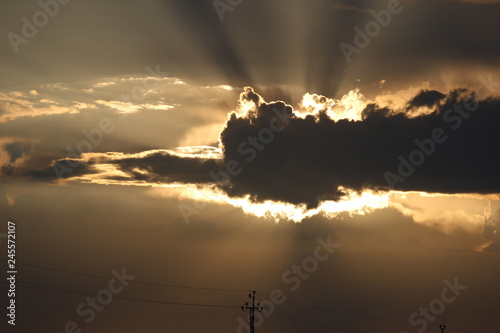 the sun behind the cloud