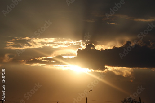 the sun behind the cloud