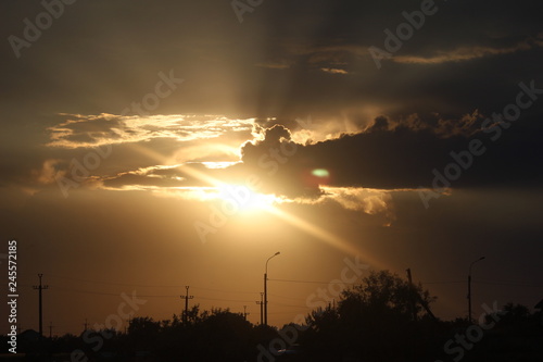 the sun behind the cloud