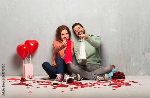 Couple in valentine day holding a lot of shopping bags