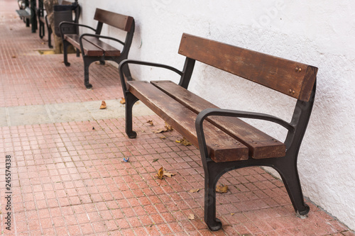 Wooden bench in the city park outdoors © satura_