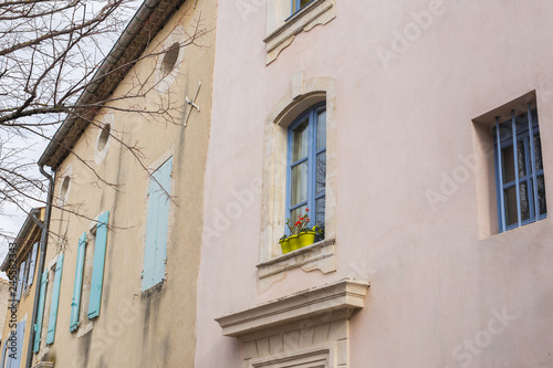 Design, architecture and exterior concept - Blue window with flower pot on the white facade