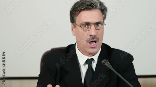 Harshly emotional speech of politician. Speaker's aggressive behavior. Election agitation.