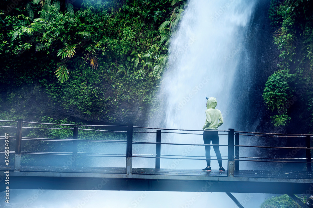 Woman enjoying Situ Gunung waterfall view