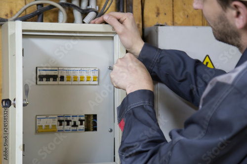 electrician working on electric panel 