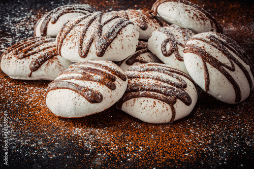 Meringues with chocoate on slate tray photo