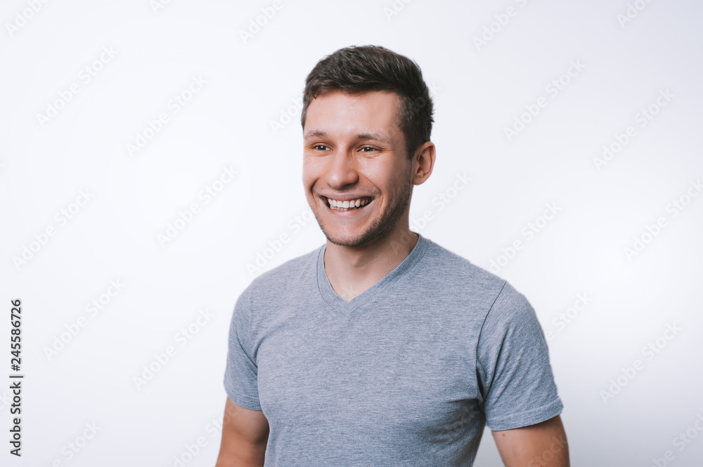 Potrait of happy young man smiling and looking away ovr white background Potrait of happy young man smiling and looking away ovr white background