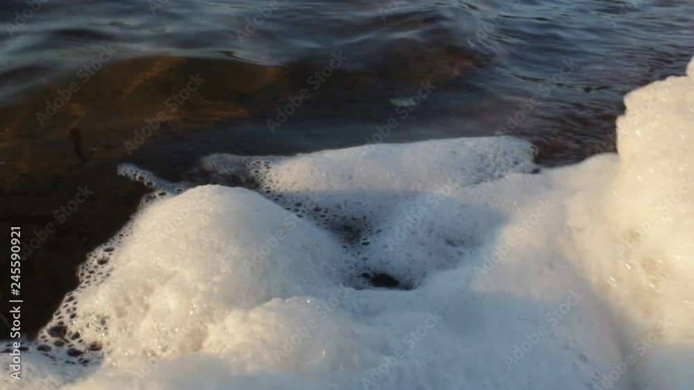 Dirty water and foam in the city pond, splashing water Dirty water and foam in the city pond, splashing water