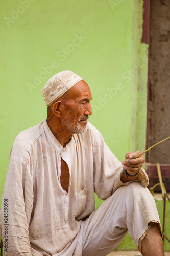 uyghur man in the street II, keriya photo