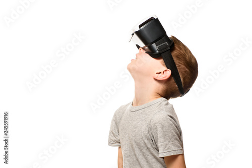 Boy experiencing virtual reality raising his head. Isolate on white background. Technology concept.