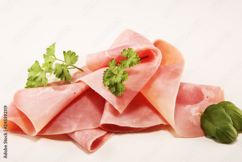 Sliced ham with parsley on table. Fresh prosciutto. Pork ham sliced. Sliced ham with parsley on table. Fresh prosciutto. Pork ham sliced.