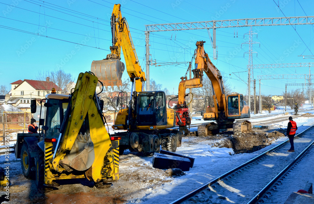 Preparing the surface of the earth for laying railways. Excavator Digging trenches for laying communications. Bulldozer and excavator dig trenches for laying railway rails Preparing the surface of the earth for laying railways. Excavator Digging trenches for laying communications. Bulldozer and excavator dig trenches for laying railway rails