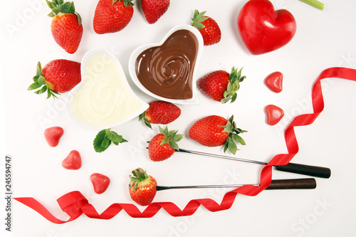 Fototapeta Naklejka Na Ścianę i Meble -  Valentine Chocolate fondue melted with fresh strawberries and dark and white chocolate. Tublips and sugar hearts.