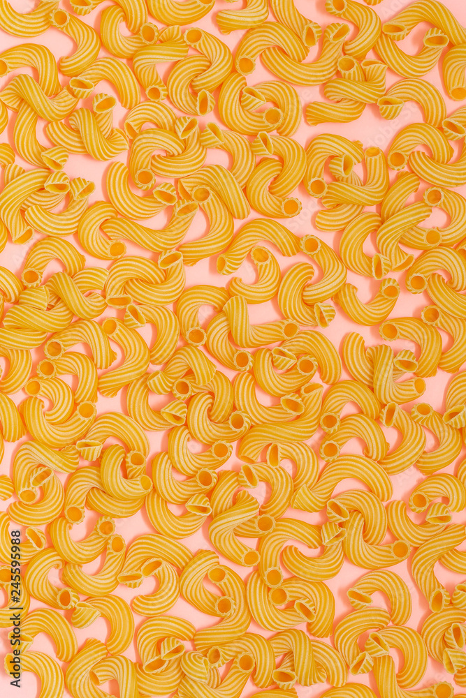 Pattern made of pasta on pink background. Flat lay. 