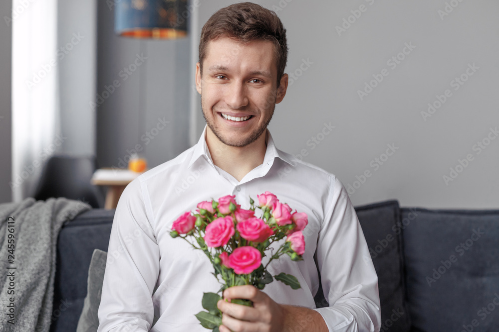 Cheerful man with bouquet of flowers Cheerful man with bouquet of flowers