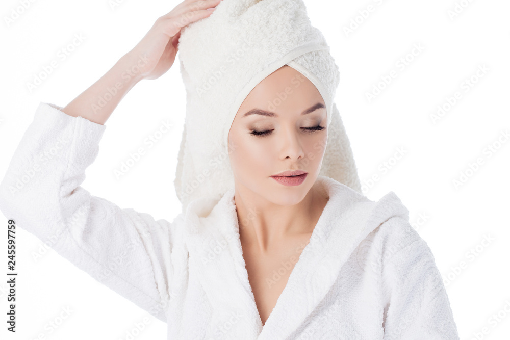 Beauty treatments after the bath. Portrait of a young beautiful woman in a Terry robe and with a towel on her head. Beauty treatments after the bath. Portrait of a young beautiful woman in a Terry robe and with a towel on her head.