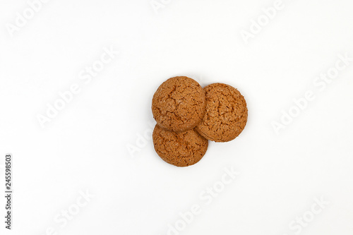 Three homemade oatmeal cookies isolated on white background. Closeup 