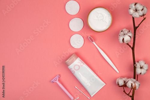 The concept of skin care. Cotton pads for removal makeup, cotton branch, cotton pads, ear sticks, pink towel. Flat lay background Top view copy space