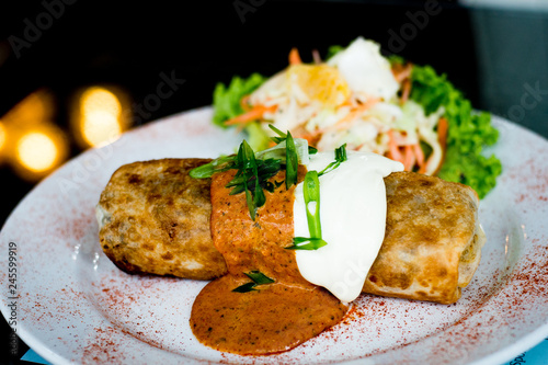 Oven Baked Chicken Chimichanga, With red beans, rice, cheese and tomato topped with sour cream photo