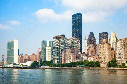 View of Midtown Manhattan skyline and the United Nations headquarters, viewed from Roosevelt Island over the East River during sunny summer day