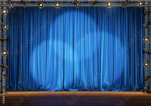 Empty theater stage with blue velvet curtains and spotlights. 