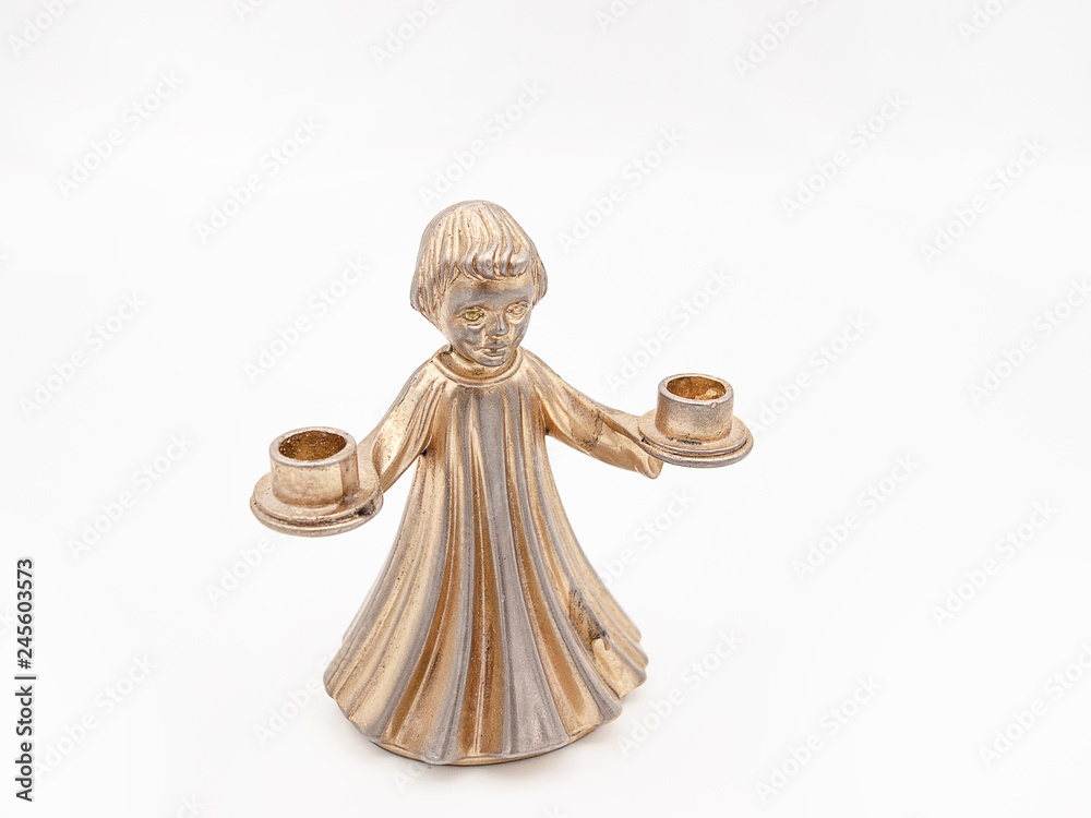 Bronze statue and candle holder in the form of a young child holding two candles isolated on a white background