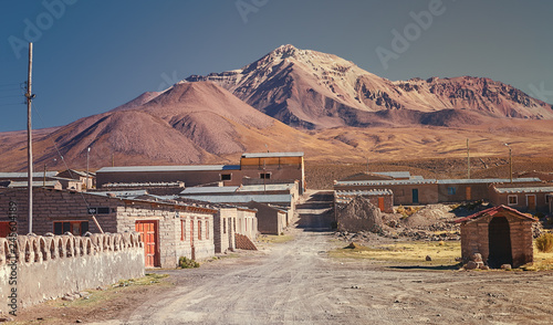 Street of the commune of Colchane, in the Tarapaca region, in the background Cerro Carabaya, Chile photo
