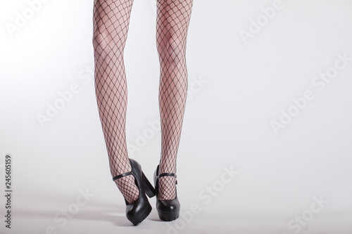 Woman naked legs and black heels