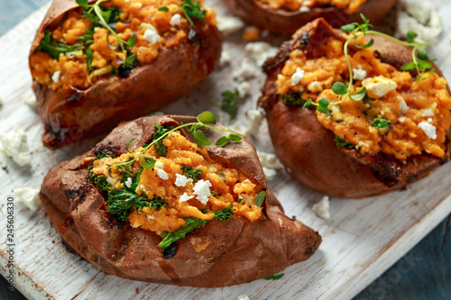 Fotografia Roast sweet potato stuffed with feta cheese and kale