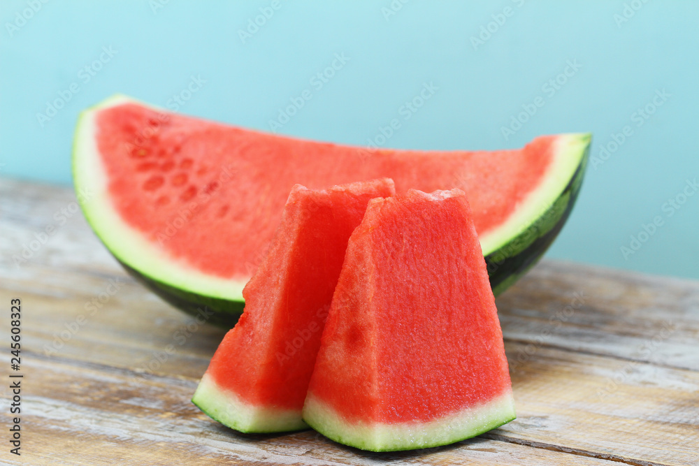 Slices of sweet and fresh watermelon on wooden surface
