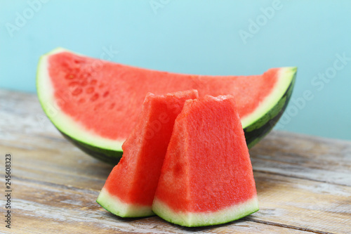 Slices of sweet and fresh watermelon on wooden surface 