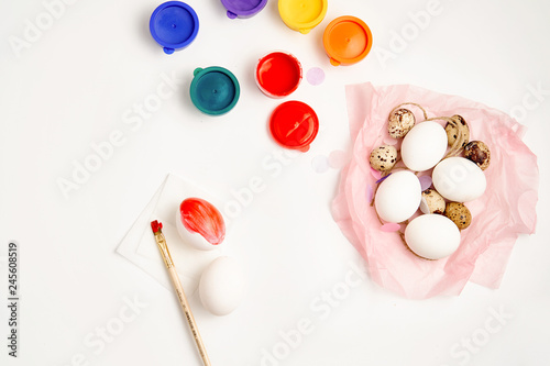 Chicken and quail eggs nest and paint on white background happy easter craft concept
