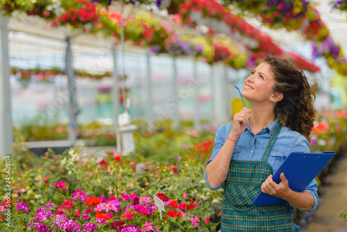 Young woman entrepreneur working in flower garden