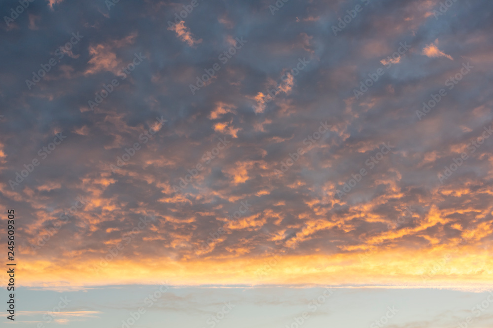Fototapeta premium Dramatic sky covered in clouds colored by morning light