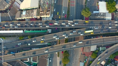 Top view of elevated expressway. Beautiful aerial shot of the curve of suspension bridge in daytime in Bangok, Thailand. Scenic road, big city life and transportation concept. photo