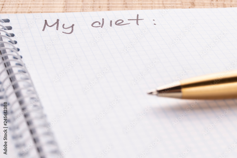 Top view workplace notebook and pen on wood table background, retro effect. Inscription - My diet. The concept of healthy eating and sports lifestyle Top view workplace notebook and pen on wood table background, retro effect. Inscription - My diet. The concept of healthy eating and sports lifestyle