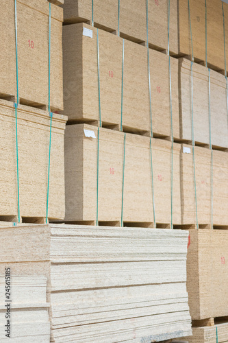 timber in warehouse. Pallet with boards in the hardware store. Packed boards in the building store. building materials. warehouse with variety of timber for construction and repair. vertical photo.